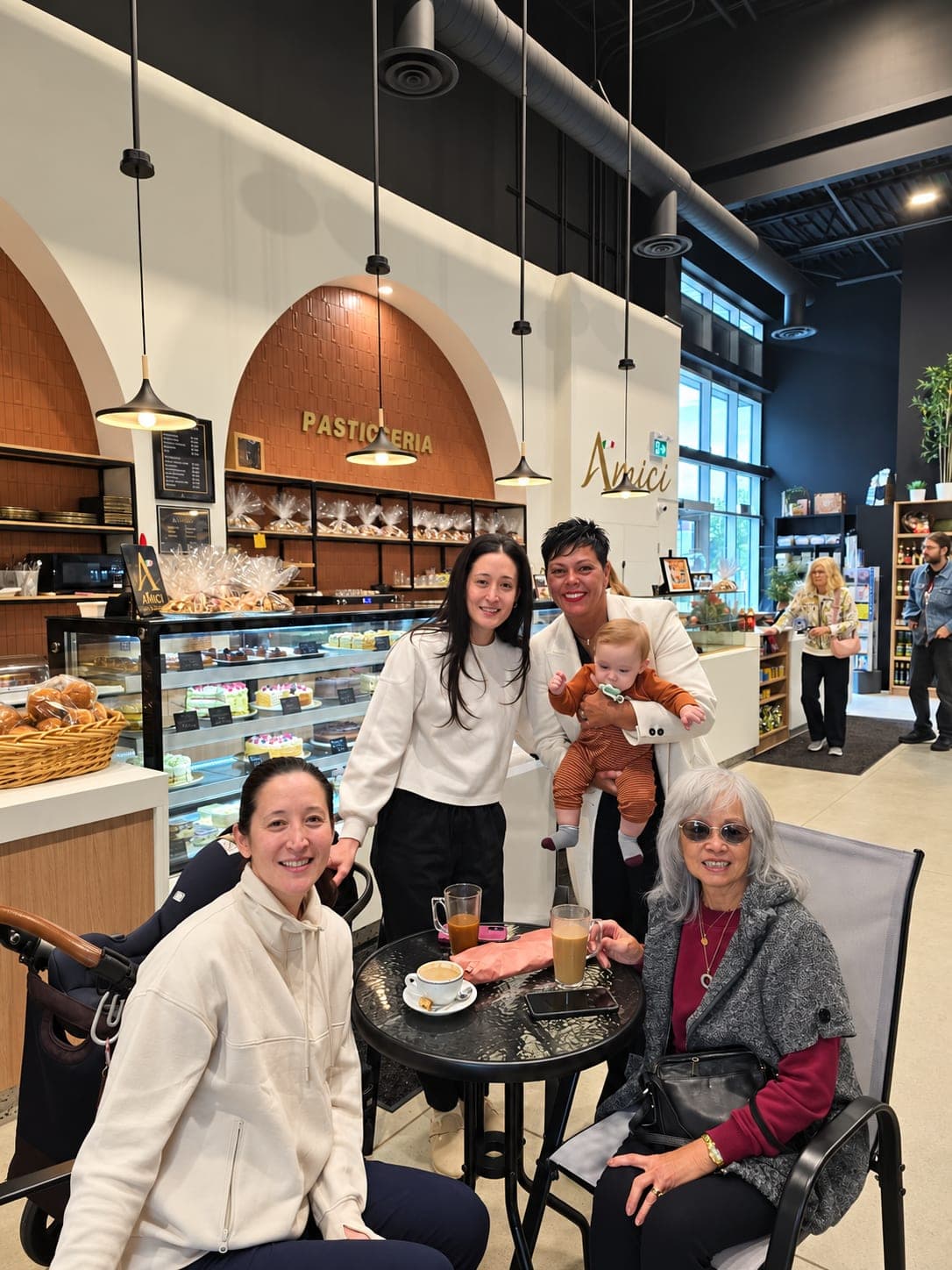 Ivana White with a family at a table near the bakery counter.