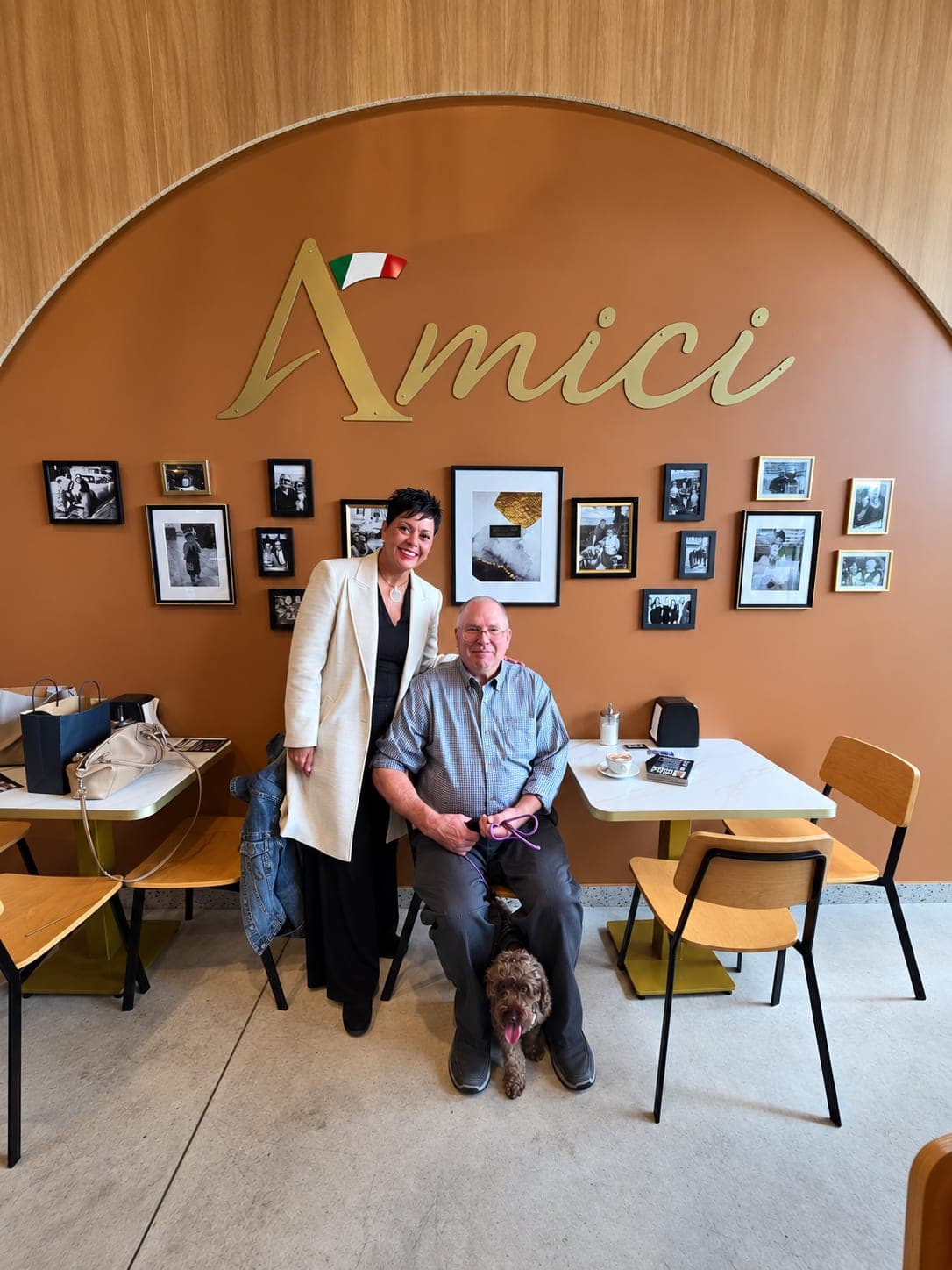 Ivana White with a seated resident and his dog at Amici.