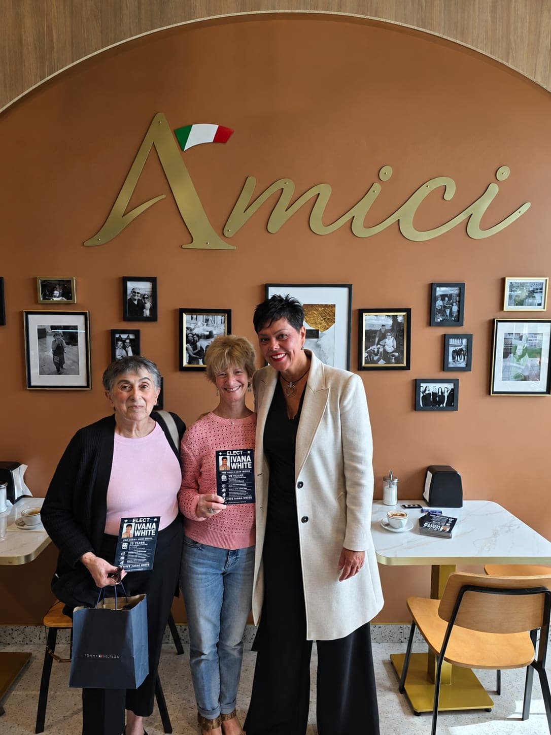 Ivana White with two residents holding her campaign flyers at Amici.